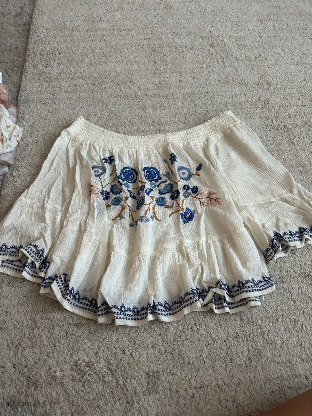 Cream off the shoulder top with navy floral design